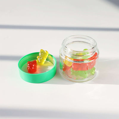 滑らかな丸いガラス 雑草の花のキャンディ 貯蔵容器 子供に耐えるスクリューキャップ
